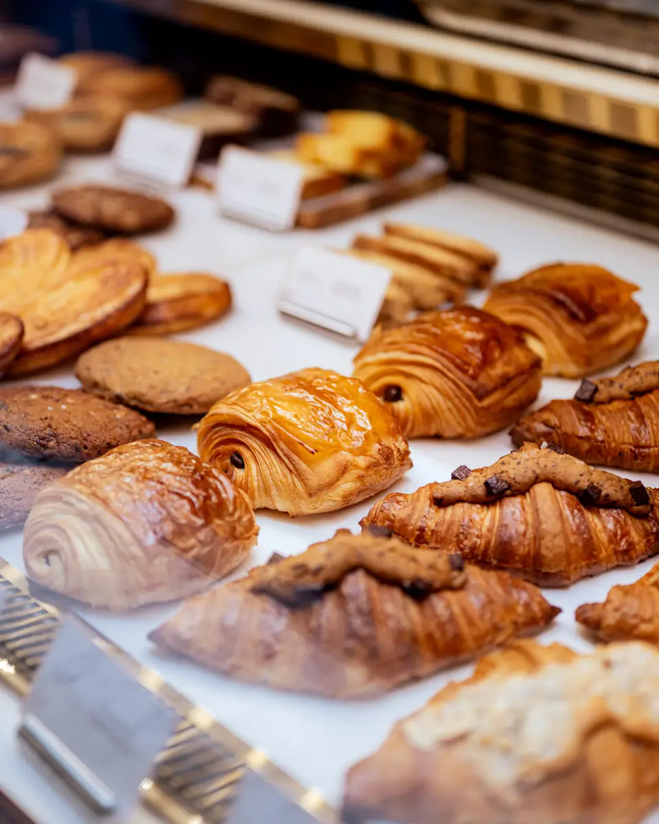 Croissants, pain au chocolat and cookies in the bakery display